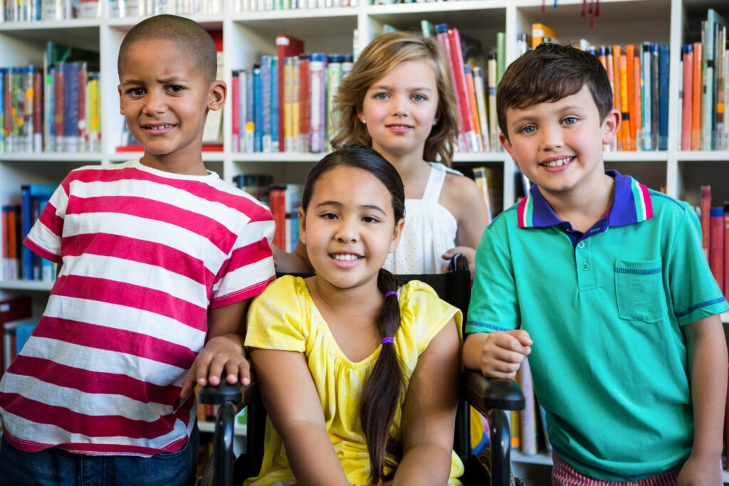 Portrait of handicapped girl with friends at school library